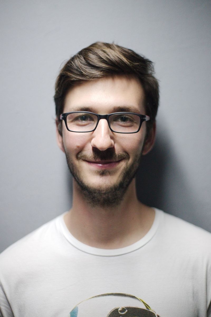 Stock portrait of a smiling man, illustrating a video chat