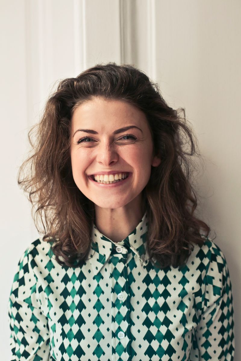 Stock portrait of a smiling woman, illustrating a video chat